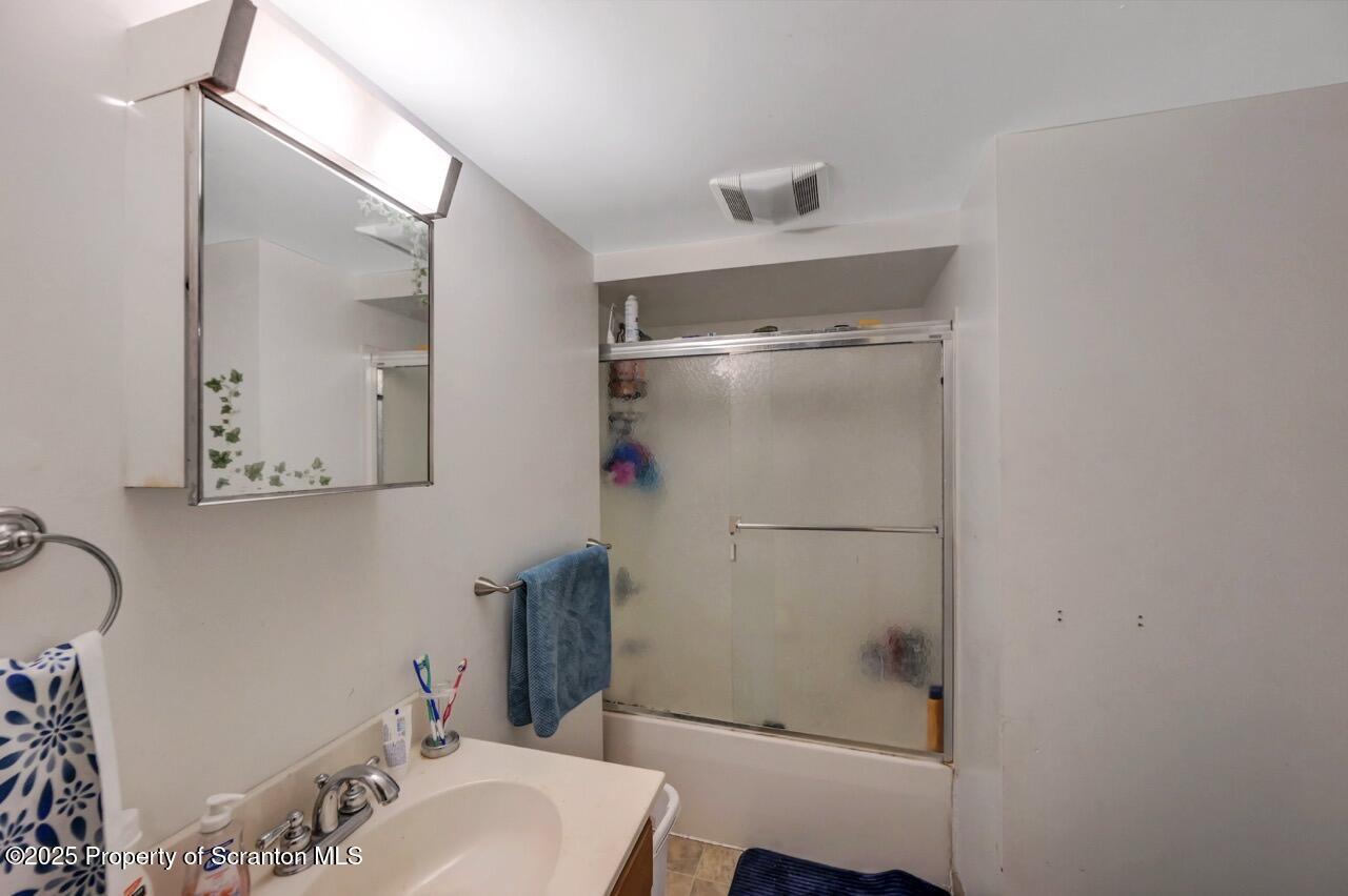 535 Green Ridge Street Scranton, PA 18509 - Photo 45 of 72 a bathroom with a shower sink vanity and toilet