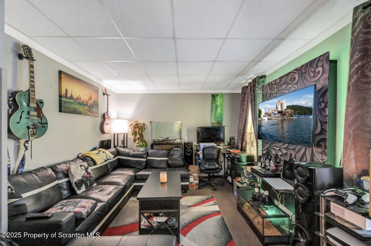 535 Green Ridge Street Scranton, PA 18509 - Photo 57 of 72 a living room with furniture a rug and a flat screen tv