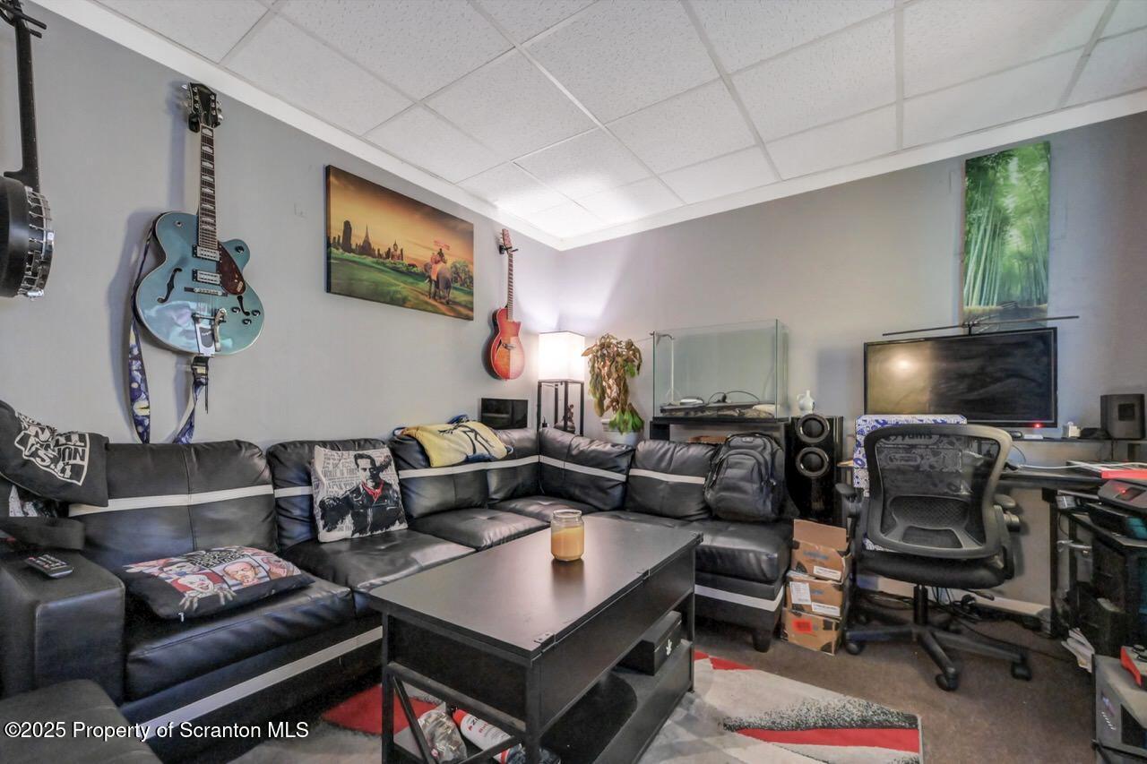 535 Green Ridge Street Scranton, PA 18509 - Photo 58 of 72 a living room with furniture a rug and a flat screen tv