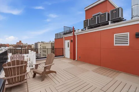 a view of building with car parked on road