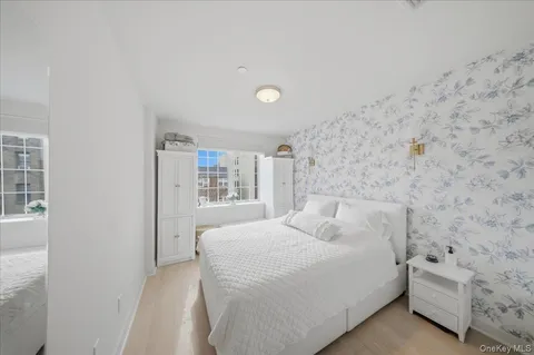 a bedroom with a bed and a wall painting