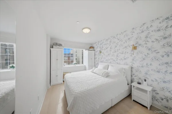 a bedroom with a bed and a wall painting