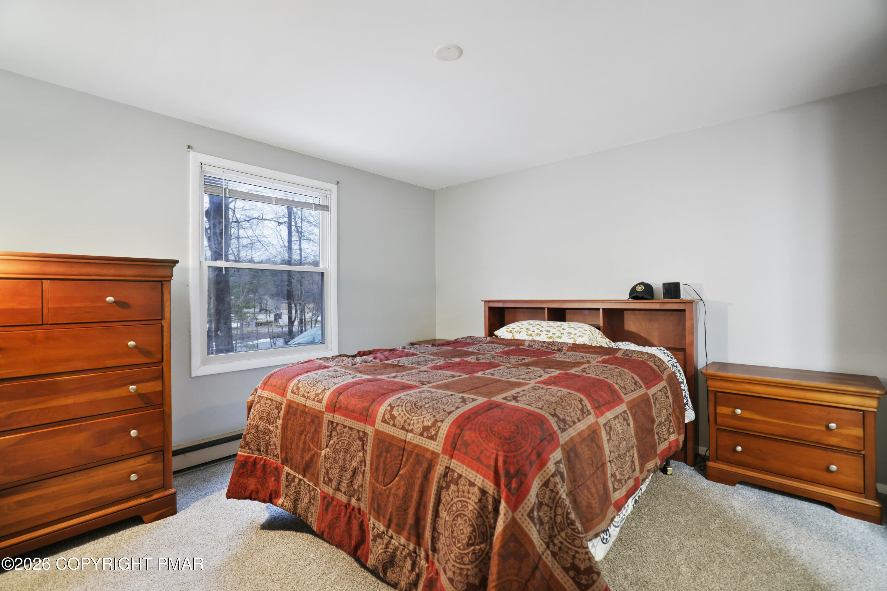 1107 Mink Trail Bushkill, PA 18324 - Photo 22 of 42 a bedroom with a bed and a window