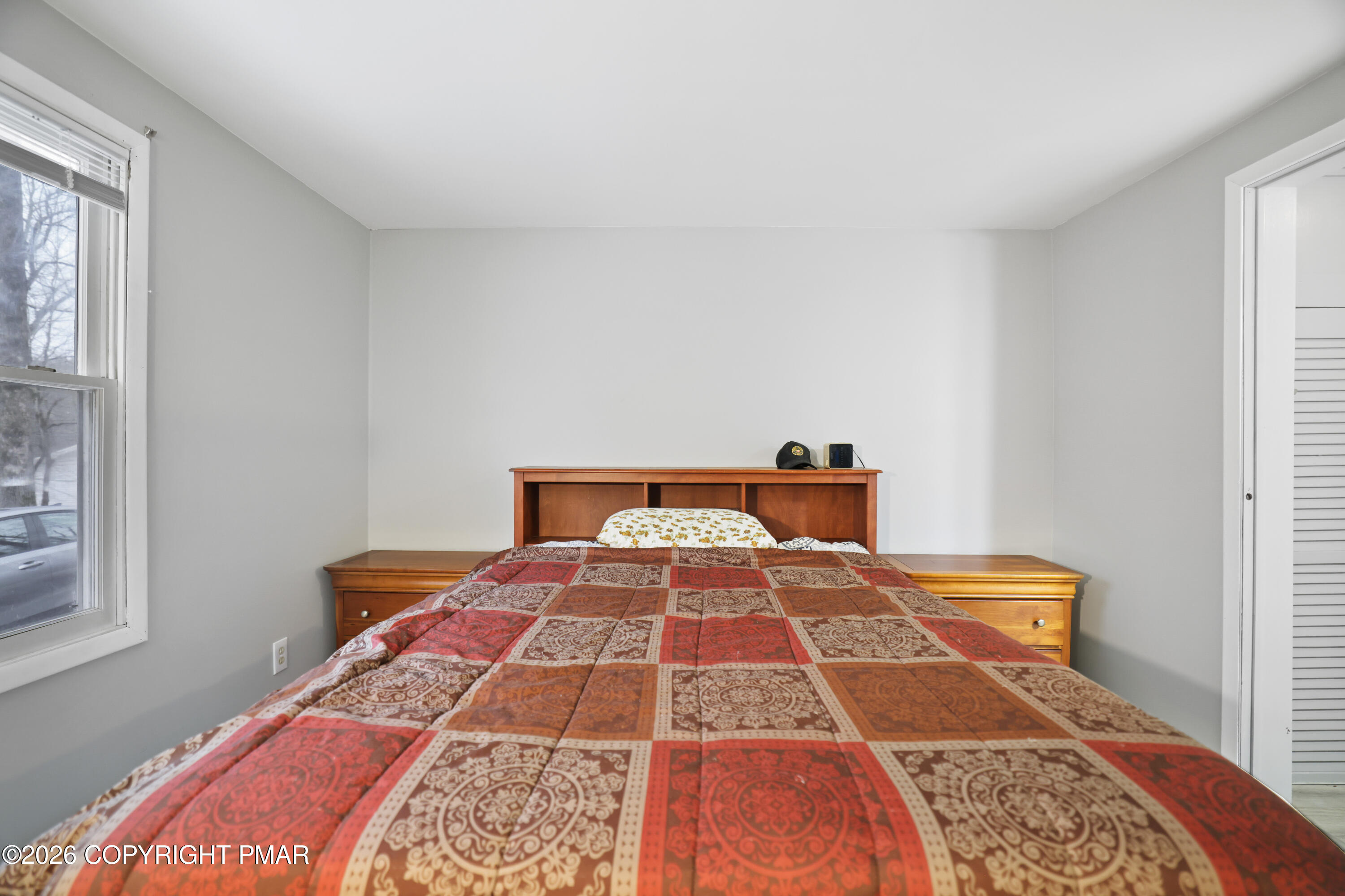1107 Mink Trail Bushkill, PA 18324 - Photo 23 of 42 a bedroom with a bed and wooden floor