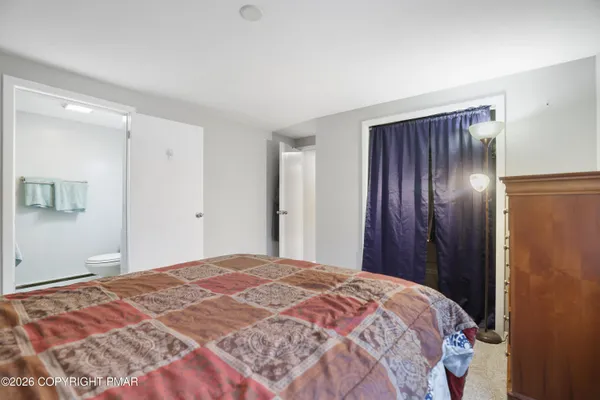 a bedroom with a bed and a mirror