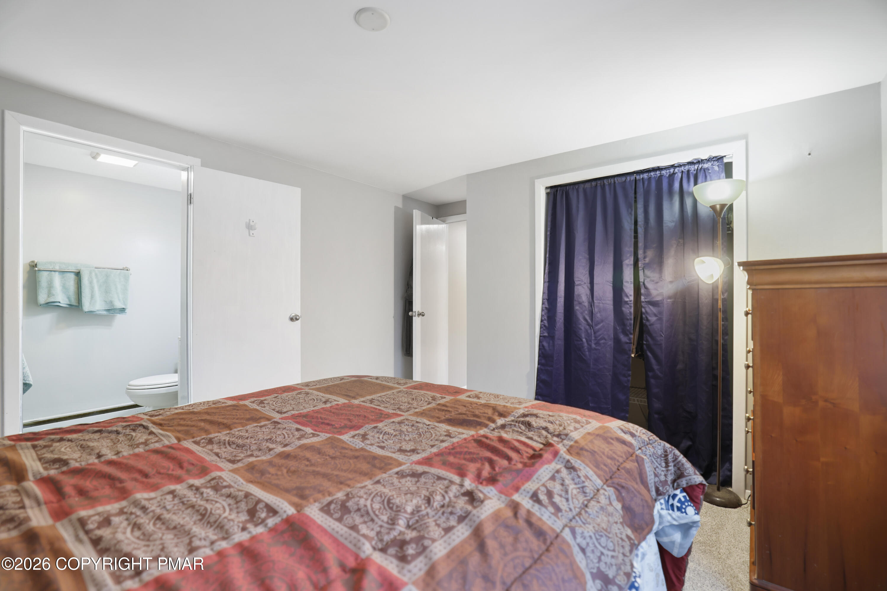 1107 Mink Trail Bushkill, PA 18324 - Photo 24 of 42 a bedroom with a bed and a mirror