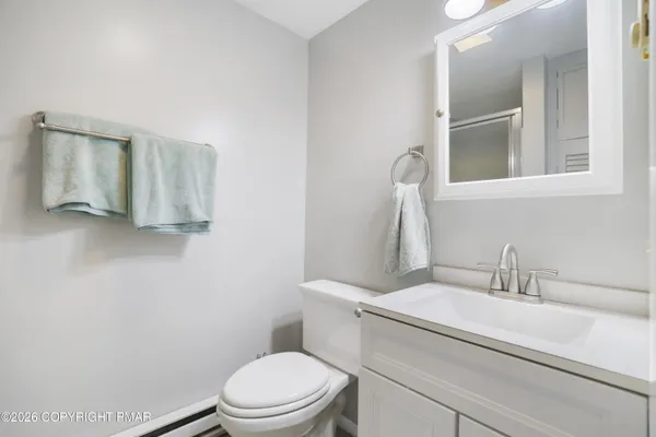 a white toilet sitting next to a bathroom sink