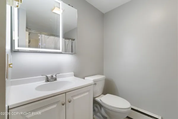 a bathroom with a shower and a curtain