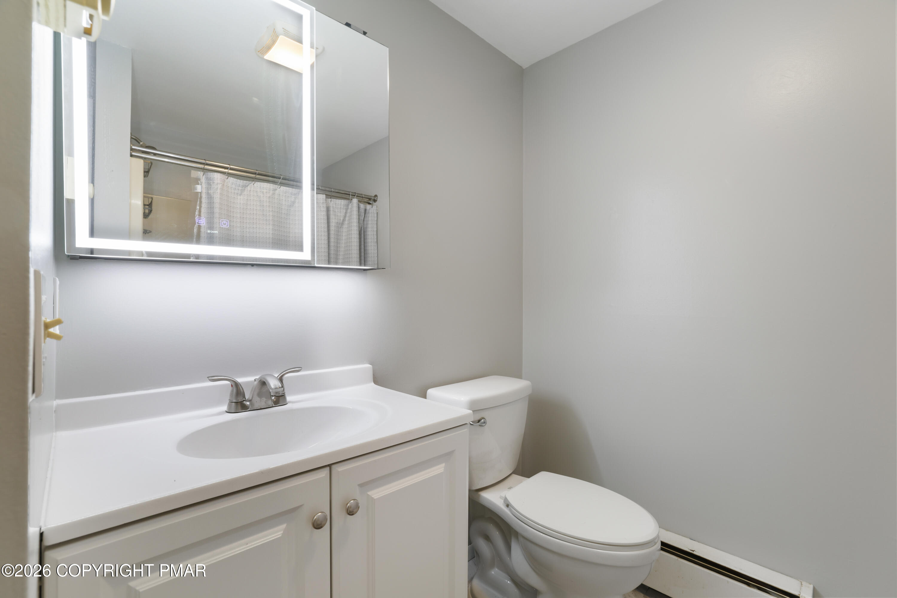 1107 Mink Trail Bushkill, PA 18324 - Photo 29 of 42 a bathroom with a sink a toilet and a mirror