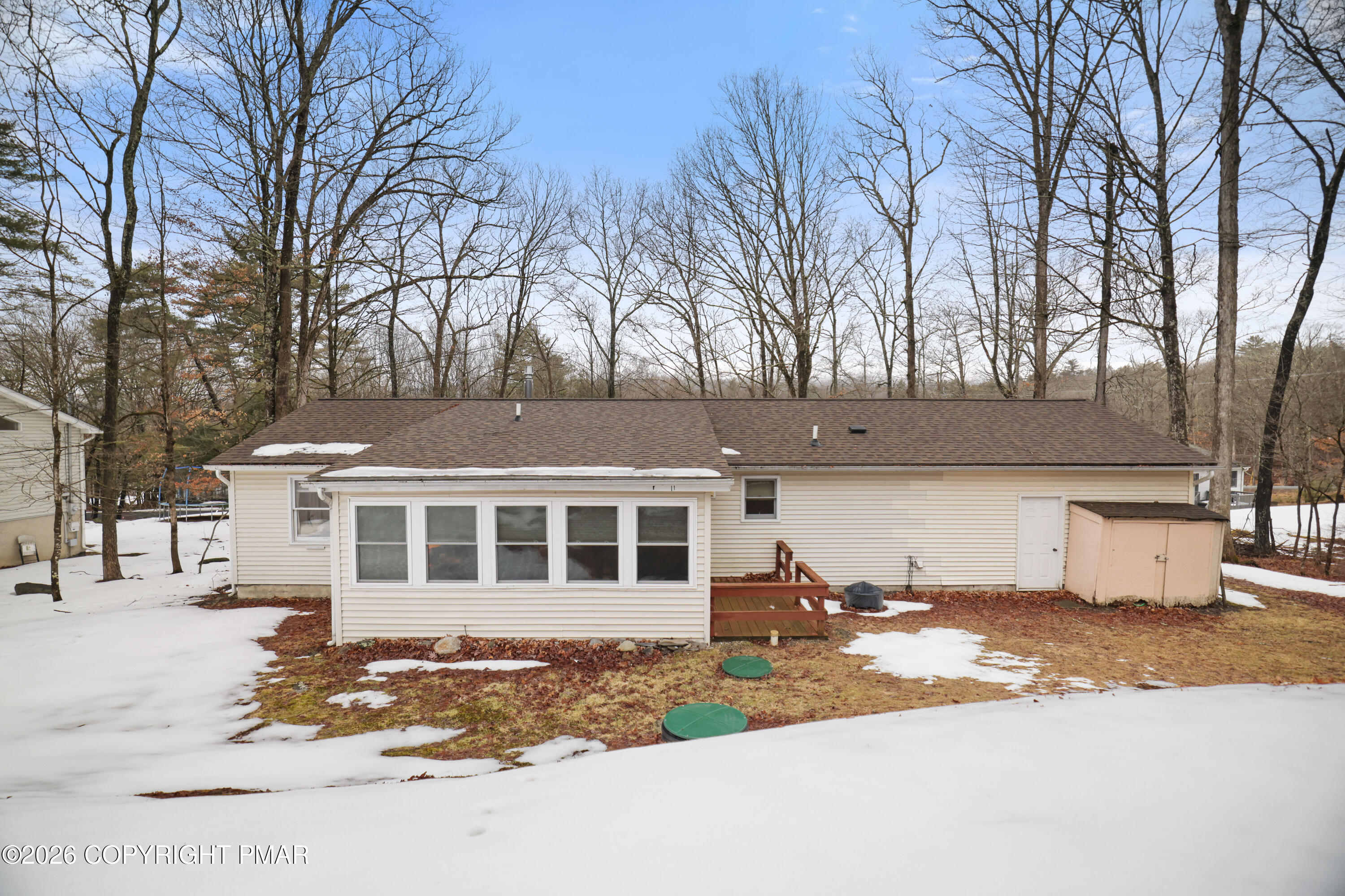 1107 Mink Trail Bushkill, PA 18324 - Photo 35 of 42 a front view of a house with a yard covered with snow