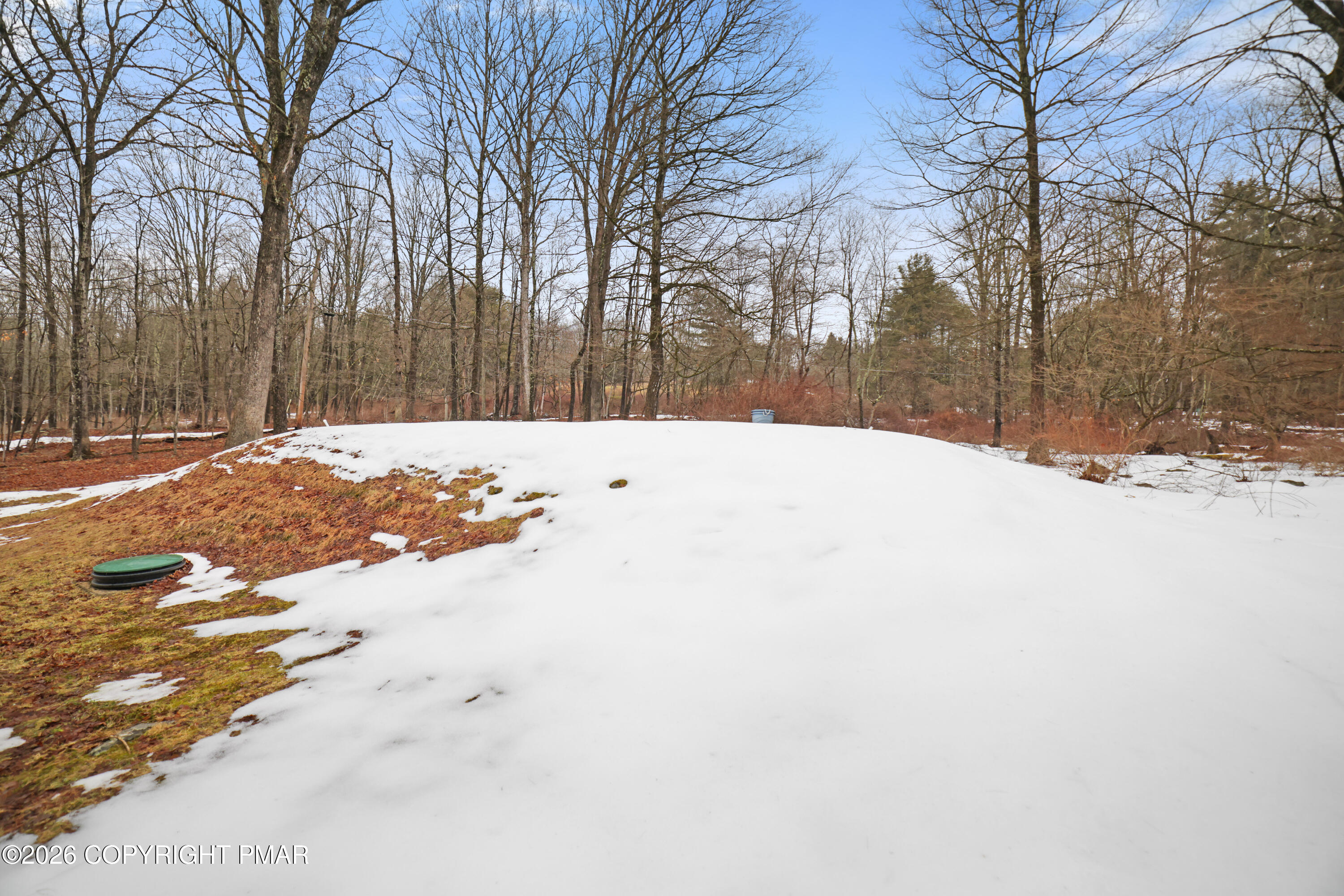 1107 Mink Trail Bushkill, PA 18324 - Photo 37 of 42 a white house with snow on the side of the road