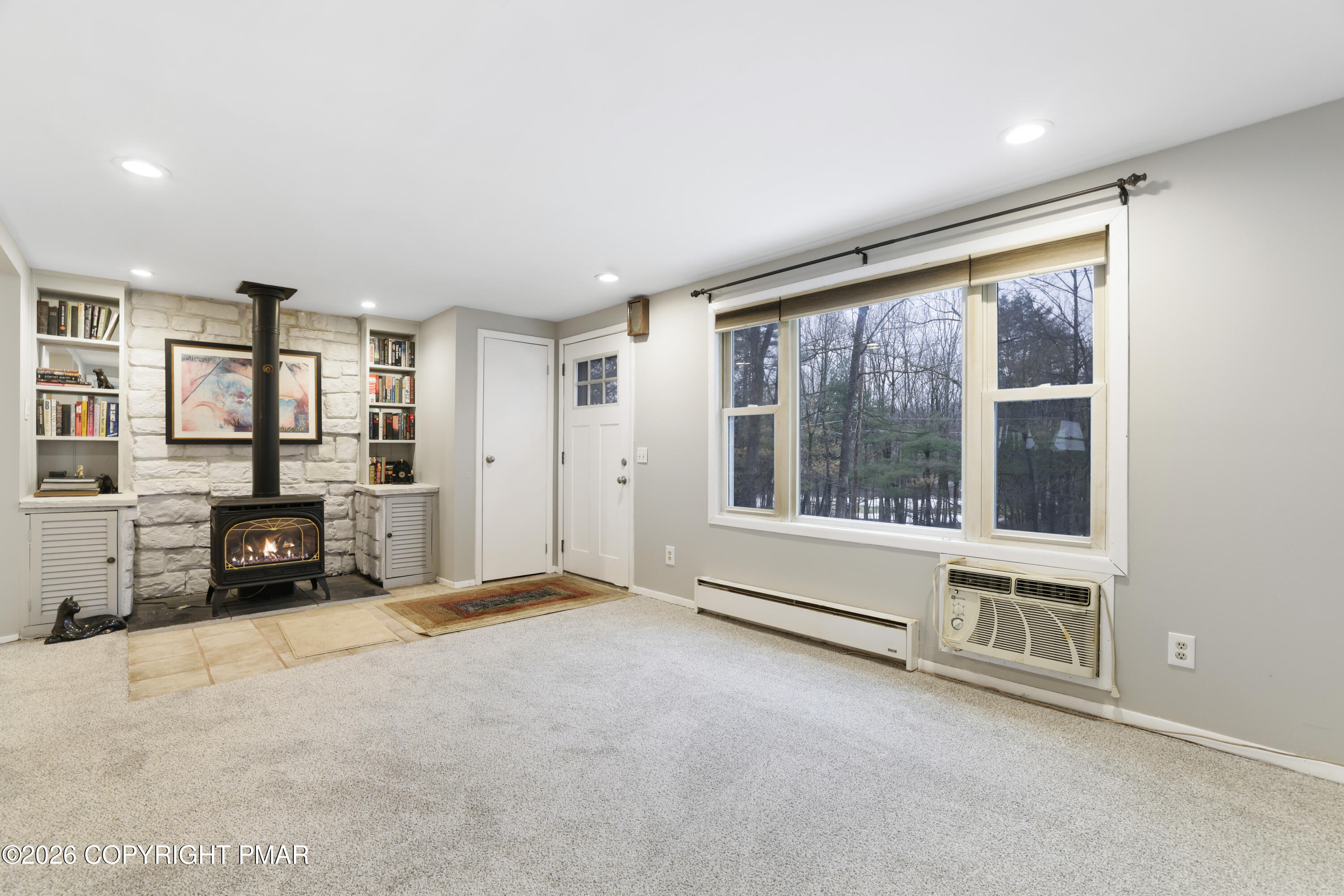 1107 Mink Trail Bushkill, PA 18324 - Photo 6 of 42 an empty room with furniture and windows