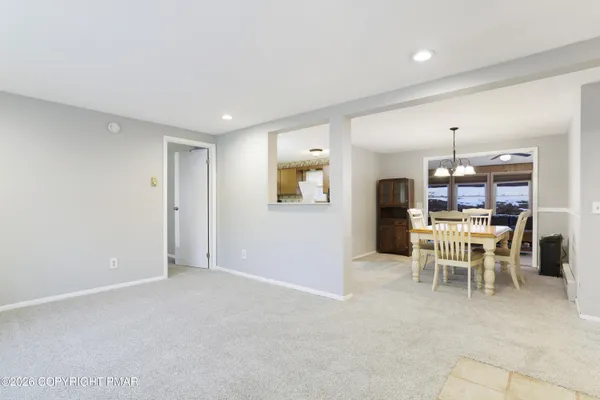 a dining room with furniture and window