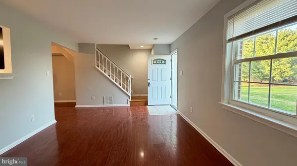 a view of an entryway with wooden floor
