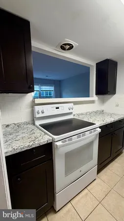 a utility room with granite countertop cabinets washer and dryer