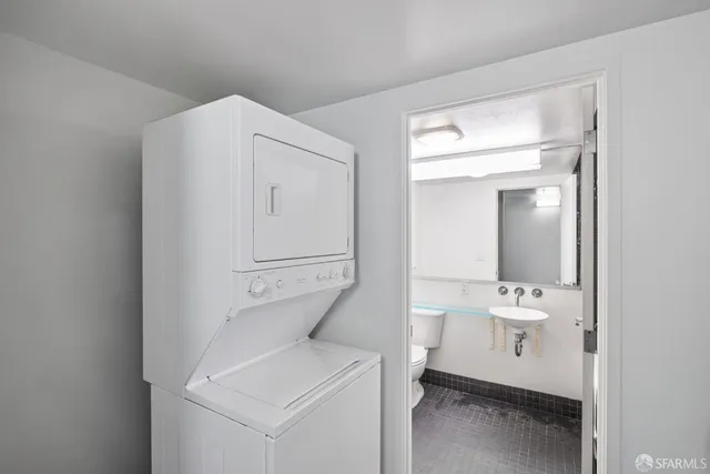 a bathroom with a sink mirror vanity and toilet