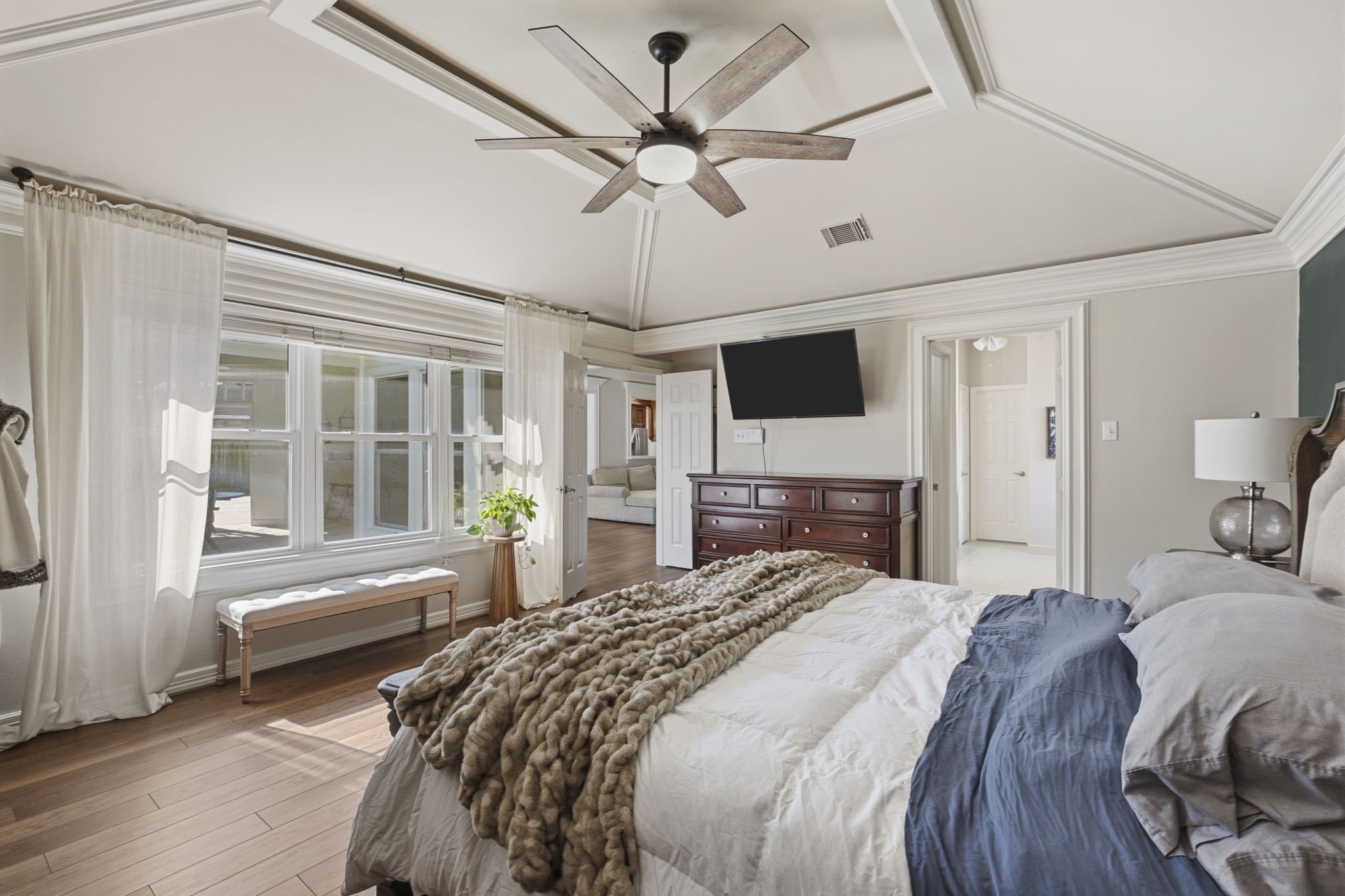 20322 Cembra Walk Spring, TX 77379 - Photo 19 of 47 a bedroom with a bed and a chandelier