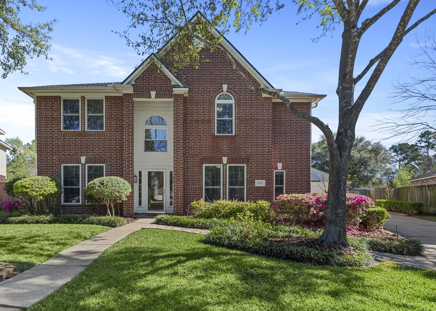 20322 Cembra Walk Spring, TX 77379 - Photo 2 of 47 a front view of a house with a yard and outdoor seating