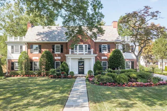a front view of a house with a garden
