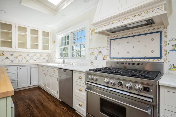 a kitchen with granite countertop a stove and a sink