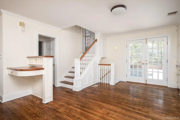 a view of entryway and hall with wooden floor