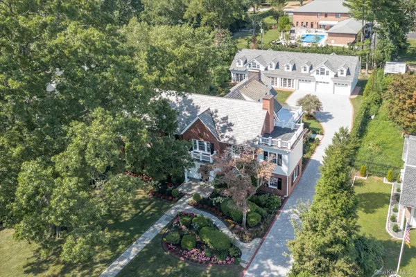 an aerial view of a house with a yard and garden