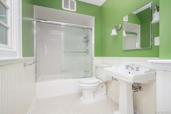 a bathroom with a sink mirror toilet and shower
