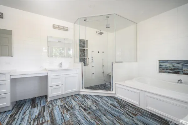 a bathroom with a sink a bathtub and a shower