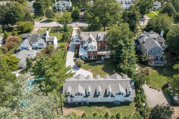 an aerial view of a house with swimming pool outdoor seating and yard
