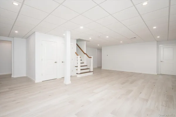 an empty room with cabinet and mirrors