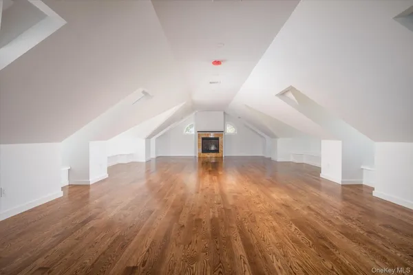 a view of a room with wooden floor and entryway