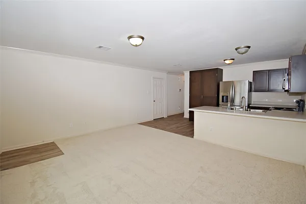 a view of kitchen and kitchen with granite countertop sink