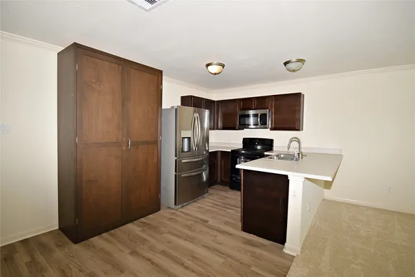 a kitchen with stainless steel appliances a refrigerator stove microwave and sink