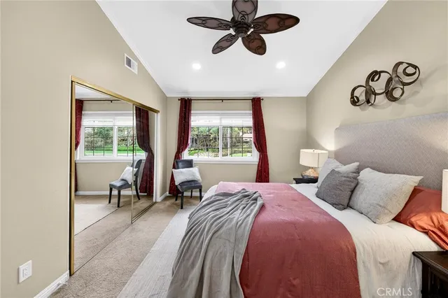 a bedroom with a bed and a window