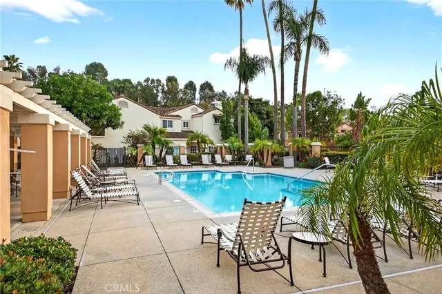 a view of swimming pool with a table and chairs