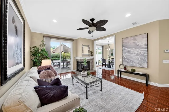 a living room with furniture floor to ceiling window and a flat screen tv