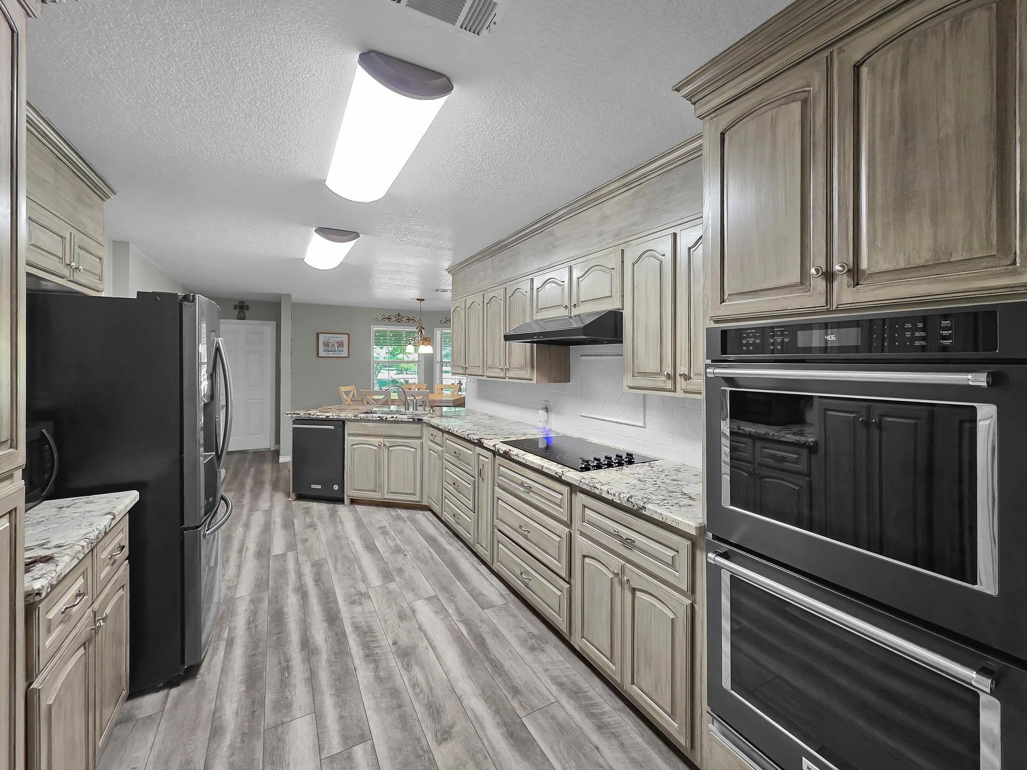 738 Parish Road Orange, TX 77632 - Photo 24 of 45 a kitchen with stainless steel appliances a refrigerator sink and cabinets