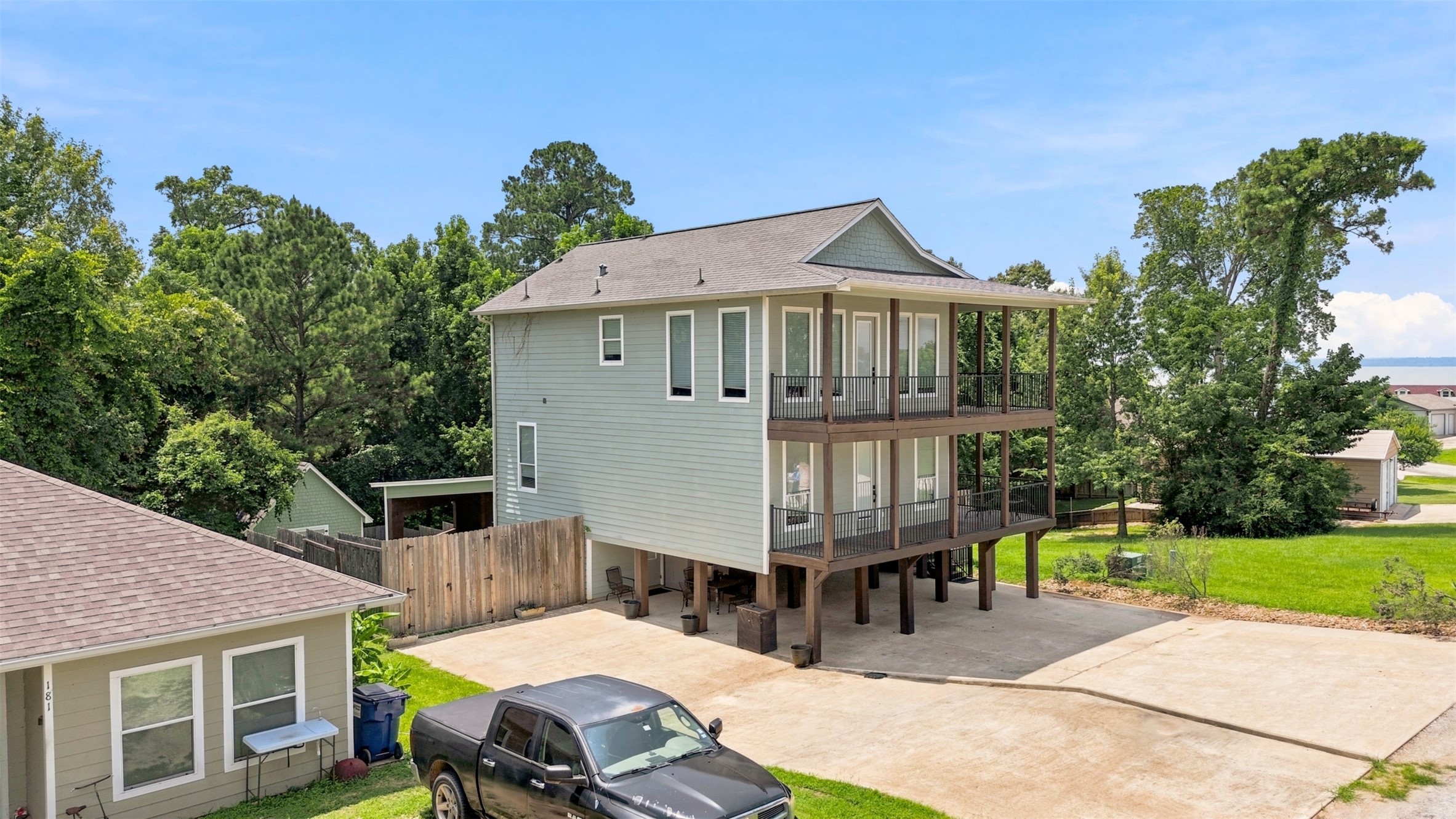 201 Coco Loop Point Blank, TX 77364 - Photo 6 of 41 Another side view, lots of parking space and the lot on the right goes with the home. You can build a shop, another home, play area, camper spot? Just endless possibilities