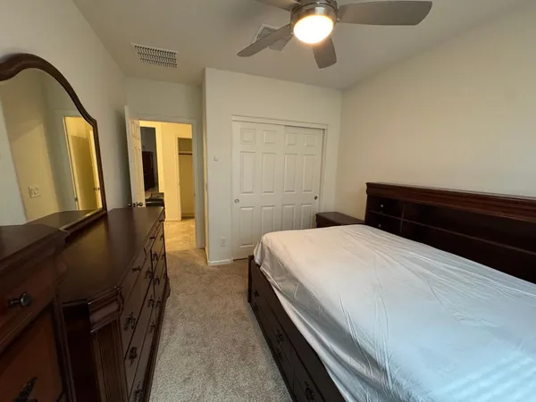 a bedroom with a bed and a chandelier