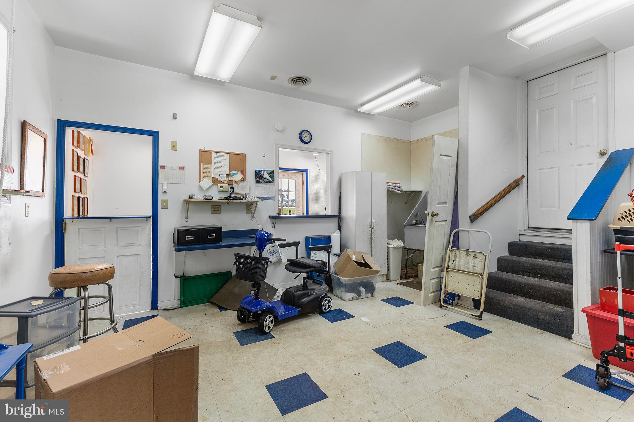 7112 East New Market Ellwood Road Hurlock, MD 21643 - Photo 34 of 41 a room with lots of chairs and a chandelier