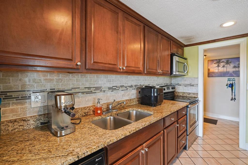 a kitchen with sink cabinets and utility