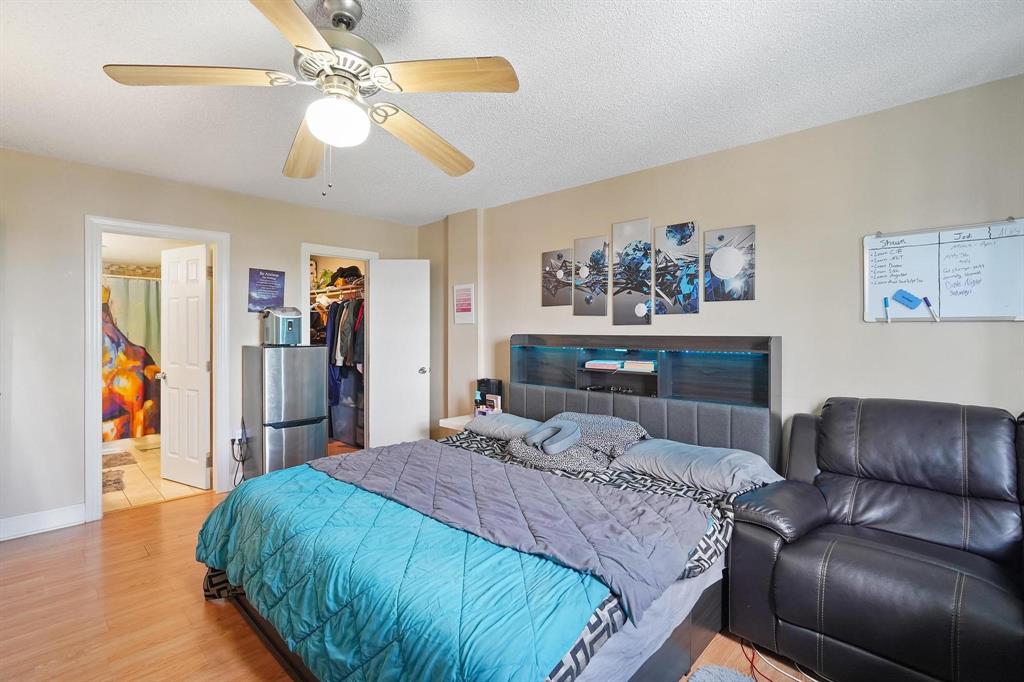 4174 Inverrary Drive, Unit 701 Lauderhill, FL 33319 - Photo 12 of 24 a bedroom with a large bed and a chandelier