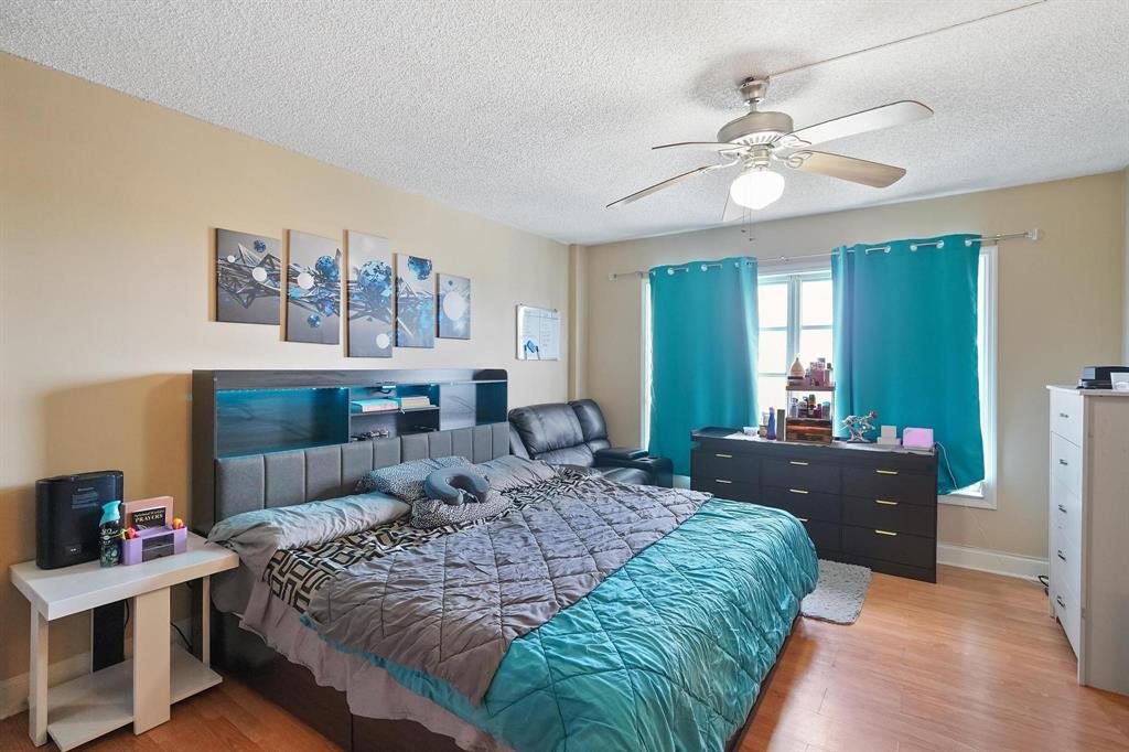 4174 Inverrary Drive, Unit 701 Lauderhill, FL 33319 - Photo 13 of 24 a bedroom with a bed and a chandelier