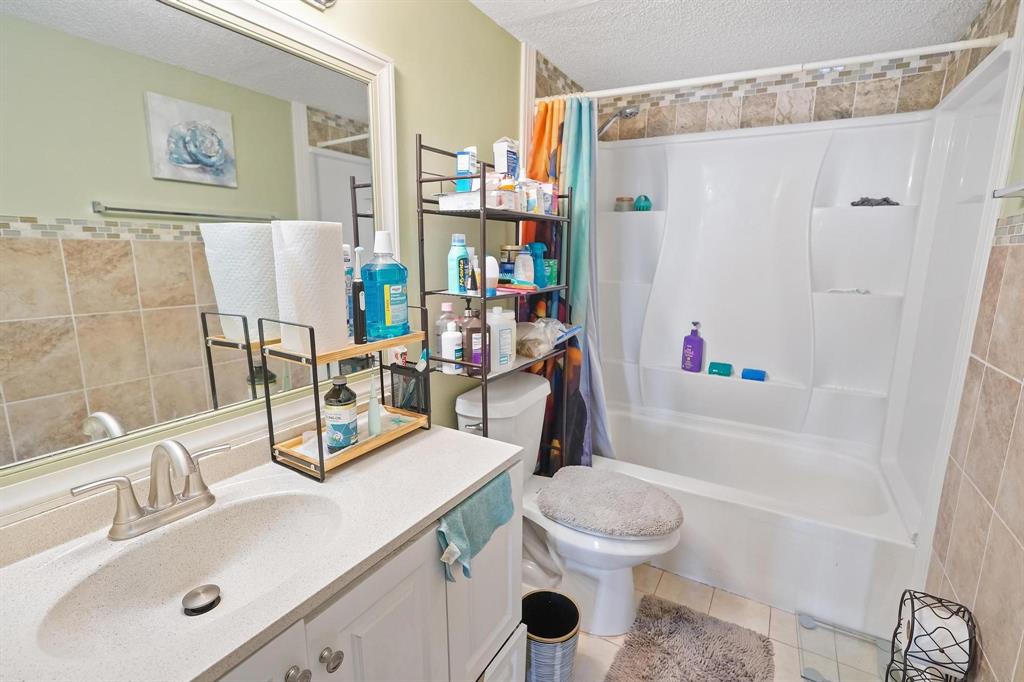 4174 Inverrary Drive, Unit 701 Lauderhill, FL 33319 - Photo 14 of 24 a bathroom with a sink toilet and shower