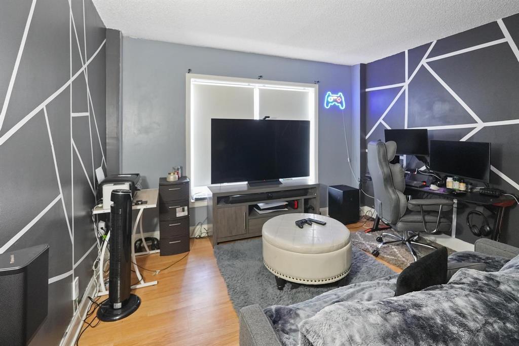4174 Inverrary Drive, Unit 701 Lauderhill, FL 33319 - Photo 18 of 24 a living room with furniture and a flat screen tv