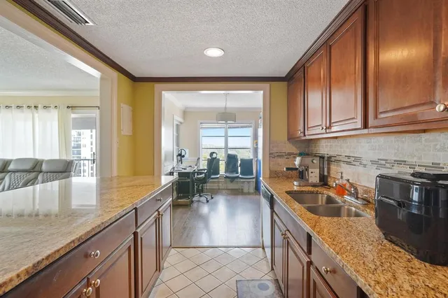 a kitchen with stainless steel appliances granite countertop sink stove and cabinets