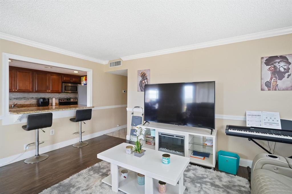 4174 Inverrary Drive, Unit 701 Lauderhill, FL 33319 - Photo 4 of 24 a living room with furniture and a flat screen tv