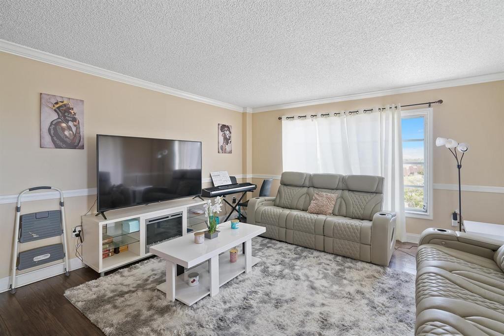 4174 Inverrary Drive, Unit 701 Lauderhill, FL 33319 - Photo 7 of 24 a living room with furniture and a flat screen tv