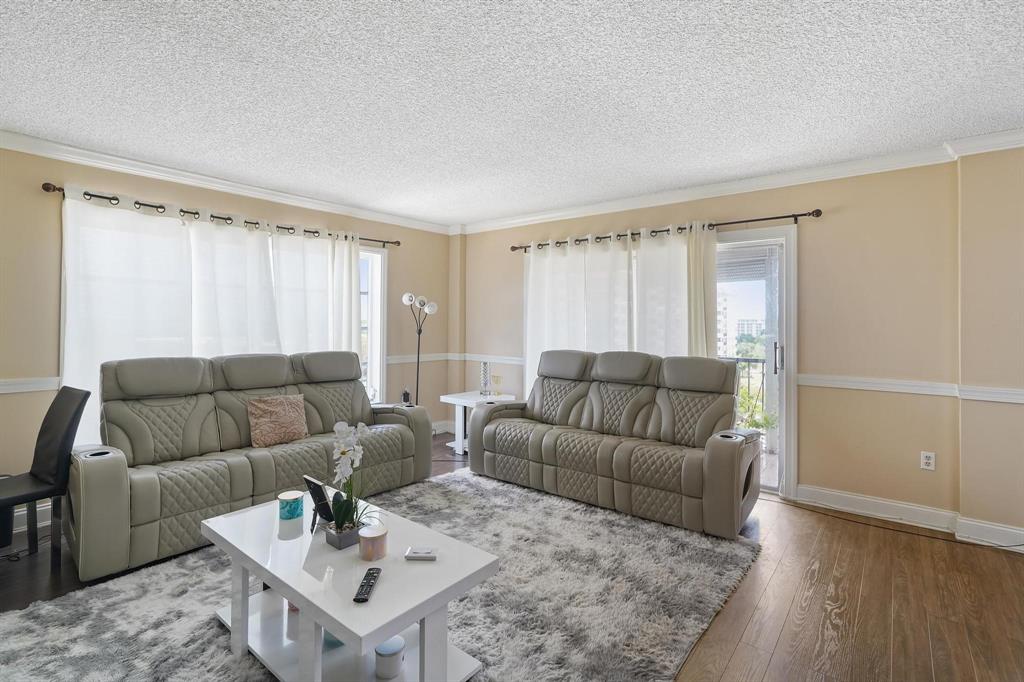 4174 Inverrary Drive, Unit 701 Lauderhill, FL 33319 - Photo 9 of 24 a living room with furniture and a wooden floor