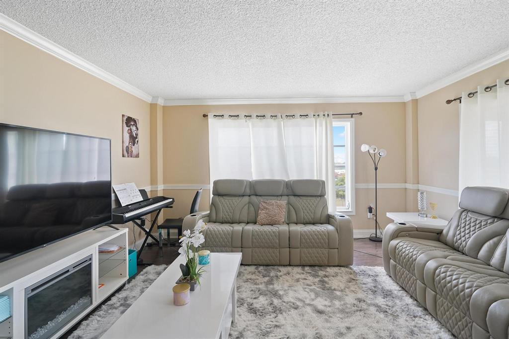 4174 Inverrary Drive, Unit 701 Lauderhill, FL 33319 - Photo 10 of 24 a living room with furniture and a flat screen tv